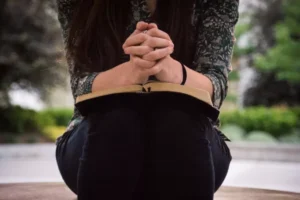 woman kneeling and praying