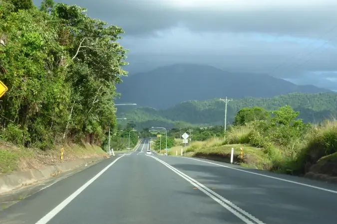 road heading towards rain clouds